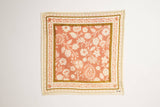 Floral patterned fabric square on a plain background