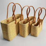 Reed basket with long leather handles