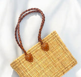 Reed basket with long leather handles