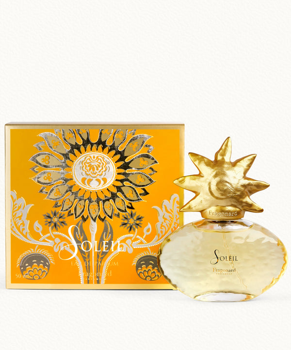 Gold perfume bottle and packaging with sun design on a white background