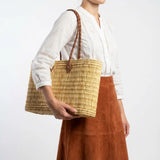 Reed basket with long leather handles