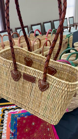 Reed basket with long leather handles